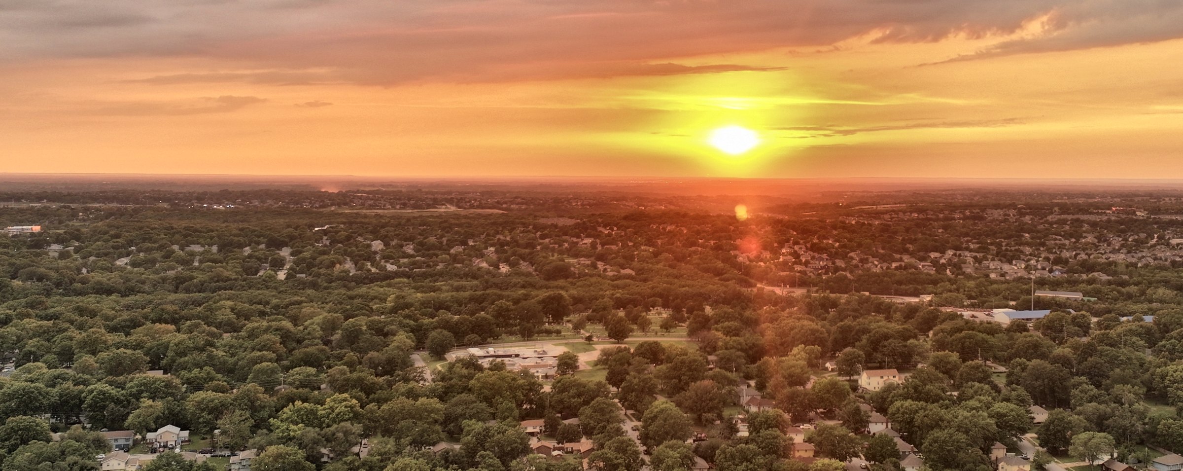 Aerial view at sunset over an established Kansas City metro neighborhood