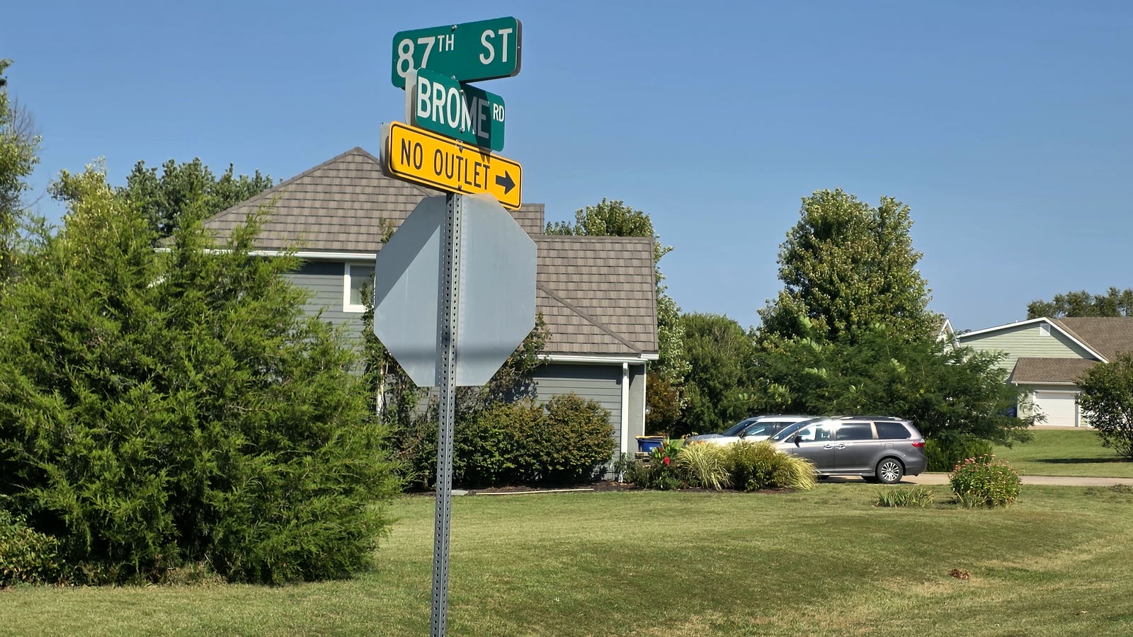 Street sign at 87th Street and Brome with a single-family home behind it in Cedar Springs II, De Soto, Kansas