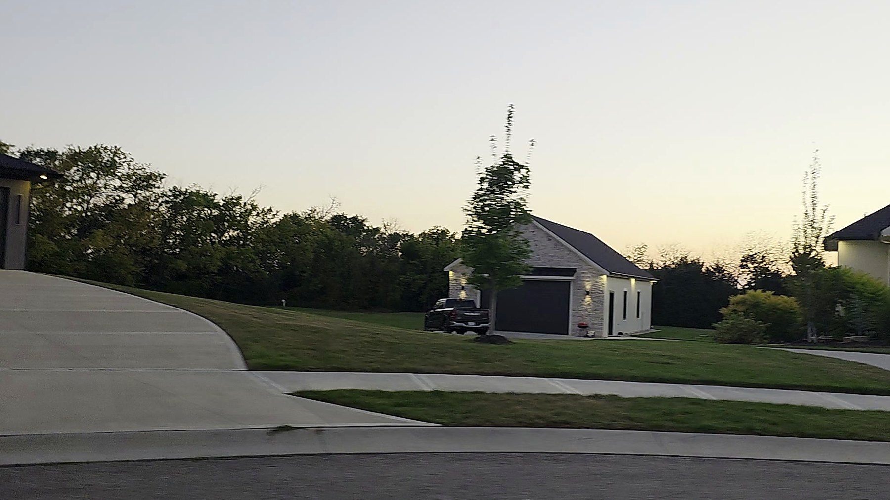 Tree-lined De Soto, Kansas street at golden hour